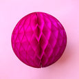 Paper honeycomb ball decoration in cerise pink and 8 inches across