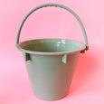 A bucket sand toy for children in light green eco plastic