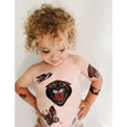 Young child with some temporary tattoos of a tiger, bird, butterfly and more