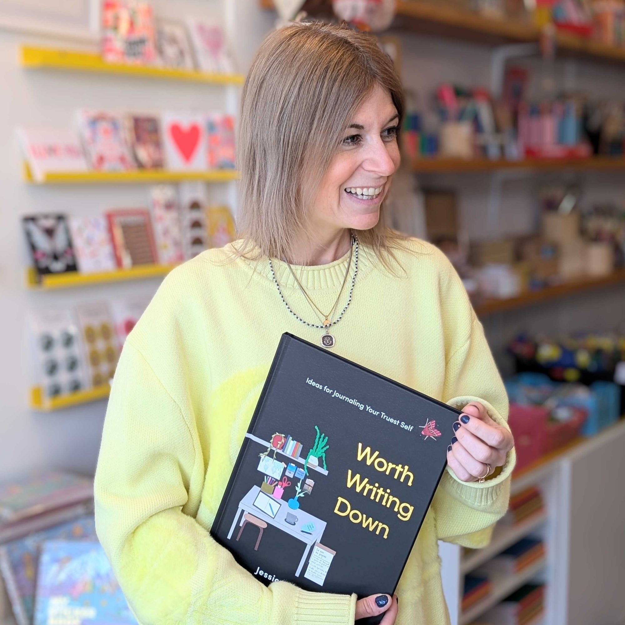 Jessica Deitcher holding Worth Writing Down at Collage Collage