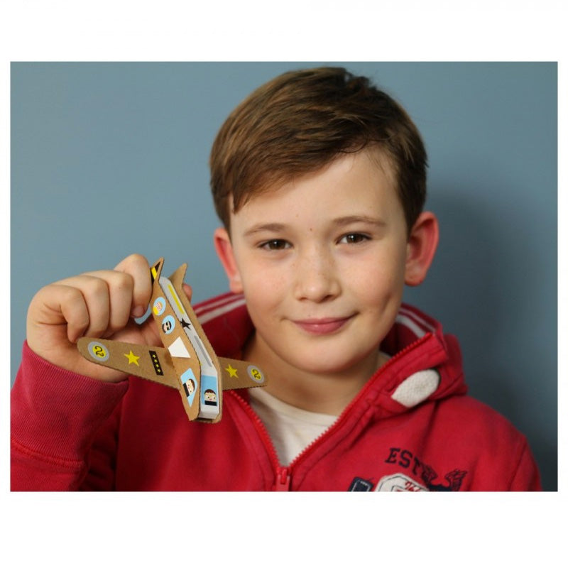 Child holding a paper craft airplane