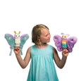 Child holding butterfly rainbow and moth stuffed animal puppets