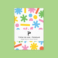 Small pocket notebook with colorful illustrations of shapes on the cover and lined paper inside.