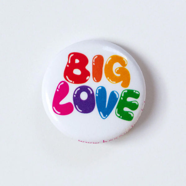 One inch button with the words Big Love in rainbow bubbly hand lettering