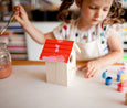 Painting a wooden birdhouse at collage collage