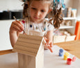 Painting a wooden birdhouse at collage collage