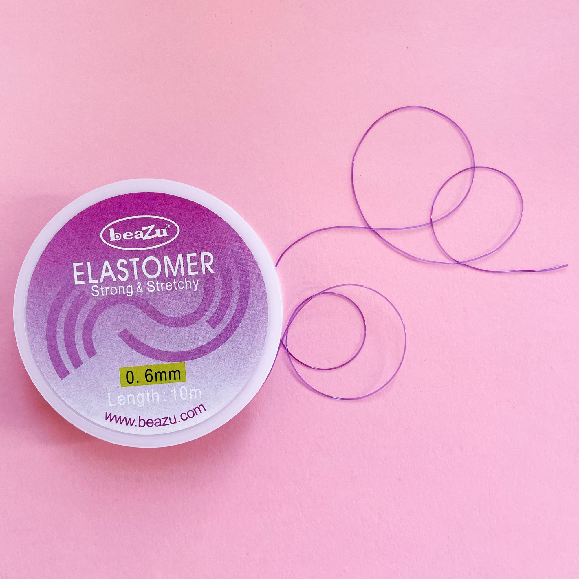 Stretchy elastic beading or jewelry cord in black 0.6mm purple thread in a 10 m spool