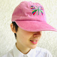 Rose pink baseball cap with a large multi-colored butterfly embroidered on the front