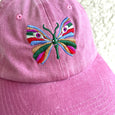 Rose pink baseball cap with a large multi-colored butterfly embroidered on the front