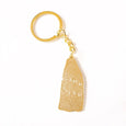 Back of a gold ghost keychain with the imprint Lorien Stern