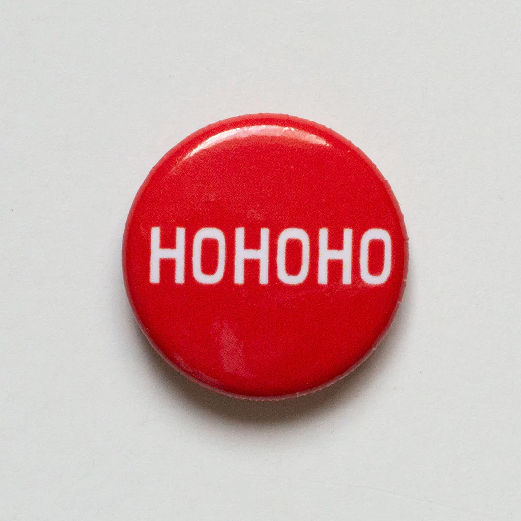 Bright red one inch button with the holiday words Ho Ho Ho in white