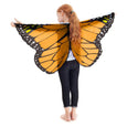 Child wearing orange monarch butterfly wings