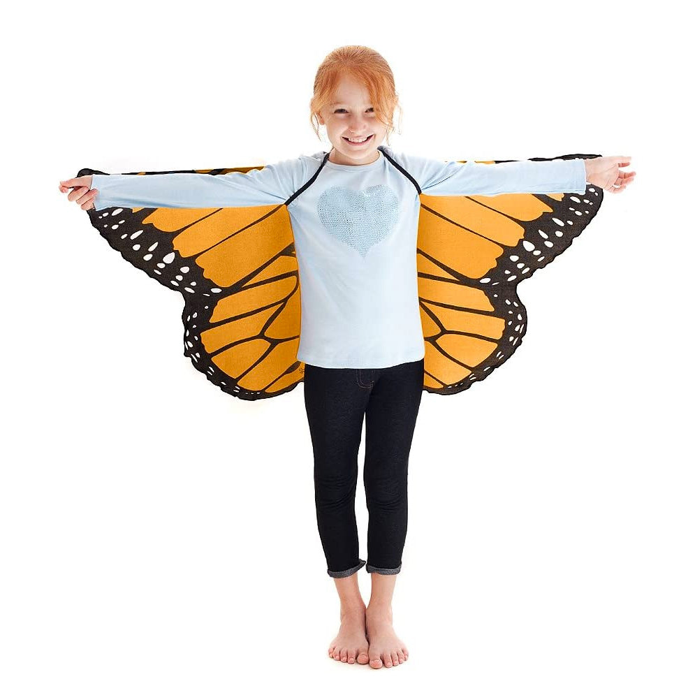 Child wearing orange monarch butterfly wings