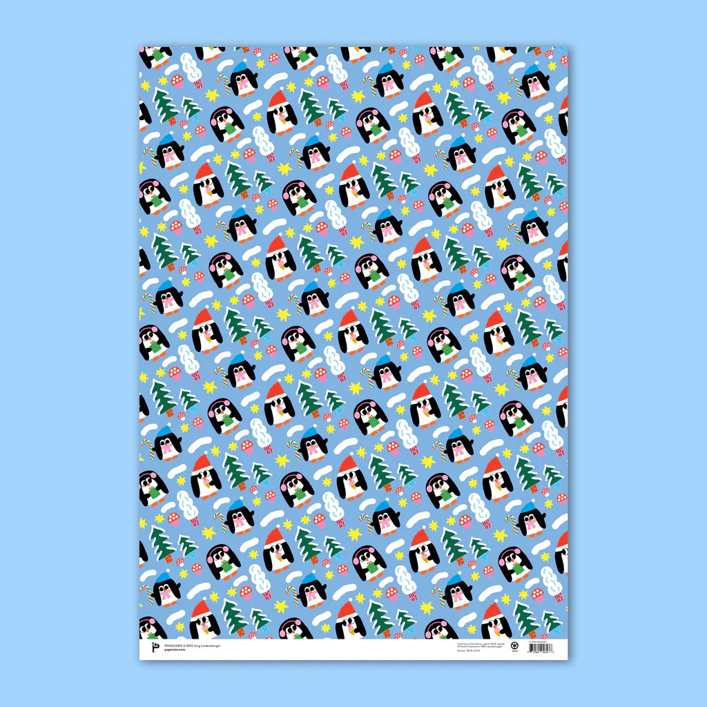 Gift wrap with illustrations of three penguins wearing winter hats holding a present, a candy cane and and an ice cream cone all on a bright blue background with stars, mushrooms and pine trees.