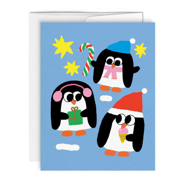 Greeting card with illustrations of three penguins wearing winter hats and each separately holding a present, a candy cane and and an ice cream cone all on a bright blue background.