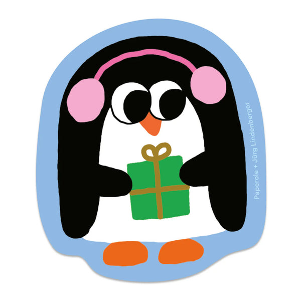 Weatherproof glossy sticker of a holiday penguin holding a present and wearing pink earmuffs.