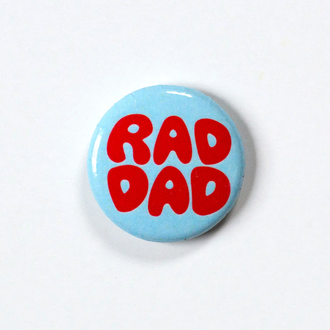 Blue 1 inch button with the words RAD DAD in big round red letters