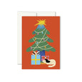 Greeting card with an illustration of a decorated holiday tree with presents and a sleeping dog underneath and a bright red background.