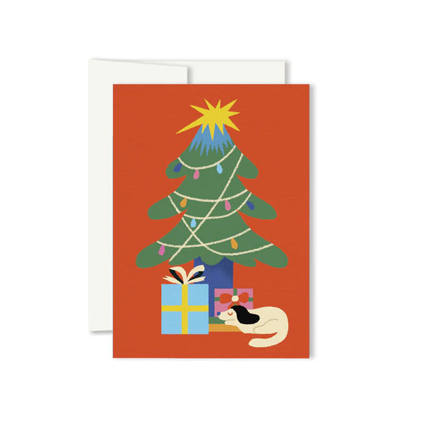 Greeting card with an illustration of a decorated holiday tree with presents and a sleeping dog underneath and a bright red background.