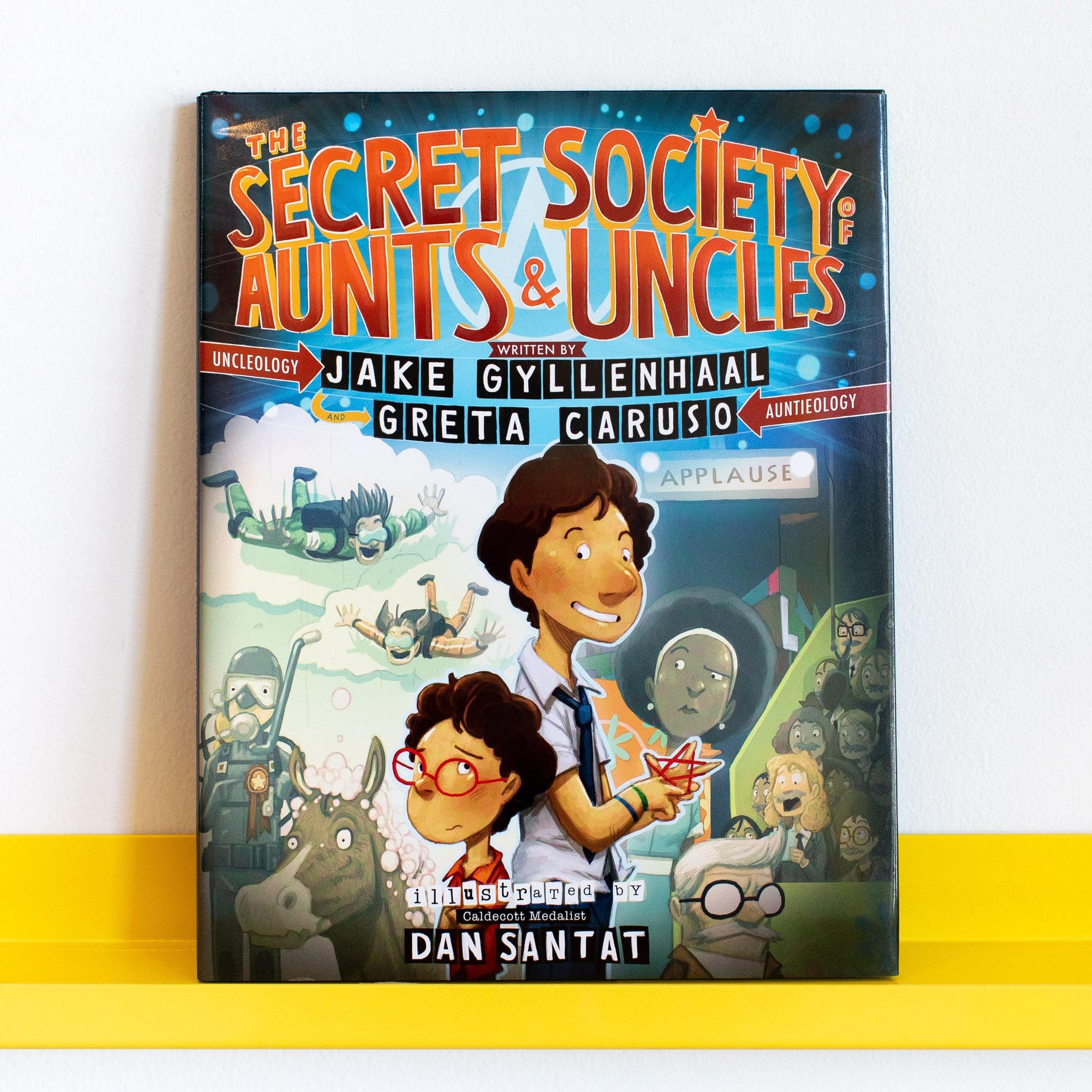 Book cover of 'The Secret Society of Aunts &amp; Uncles' with characters and text on a white background