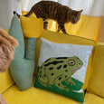 Toad at the Pond Throw Pillow Case with a bright green frog on a lily pad against a blue background