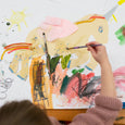Child's hand painting a Unicorn