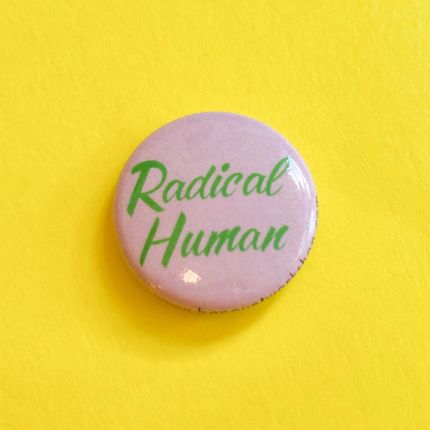 Banquet Workshop 1 inch button which says "Radical Human"