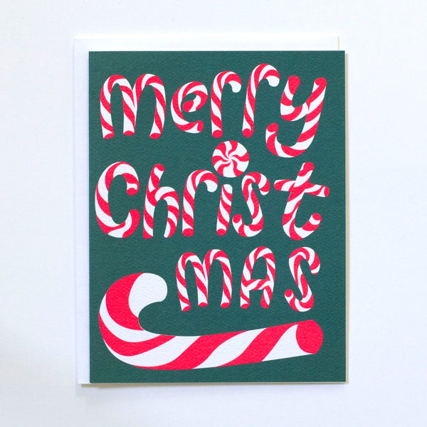 Greeting Card by Banquet with Merry Christmas spelt out in neon pink candy canes and a dark green background