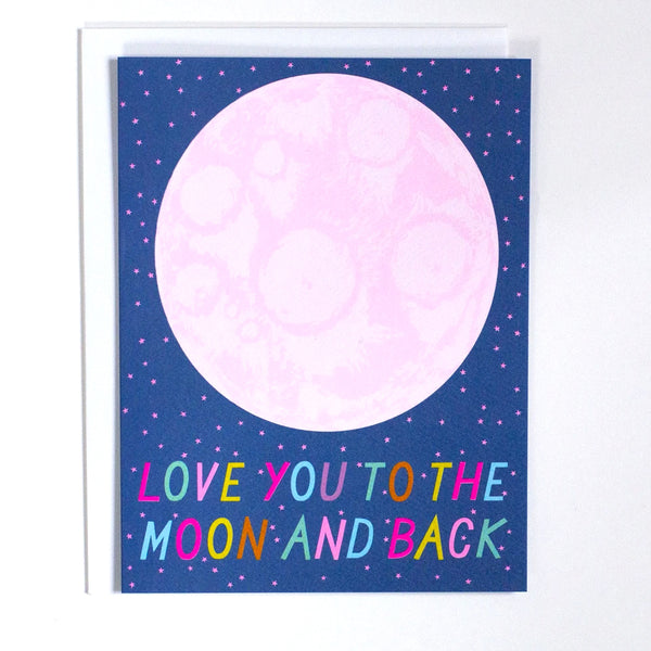 Greeting Card with the words "Love you to the moon and back" in rainbow letters with a pink moon on a blue card by Banquet Workshop