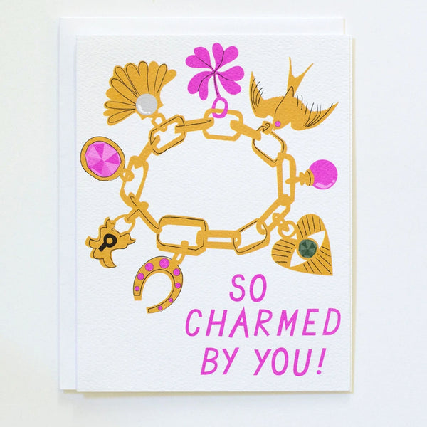 Greeting Card with an image of a charm bracelet and the words "So Charmed by you!" in bright pink, by Banquet Workshop