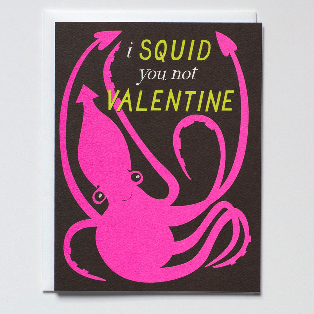Greeting Card on black paper with a big pink illustration of a squid and the words "I squid you not valentine"