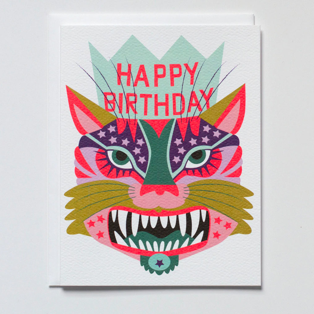 greeting card with a wild tiger face in the brightest pinks purples and blue wearing a happy birthday crown and a big toothy grin