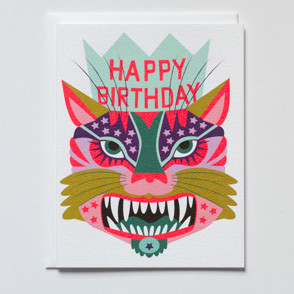 greeting card with a wild tiger face in the brightest pinks purples and blue wearing a happy birthday crown and a big toothy grin