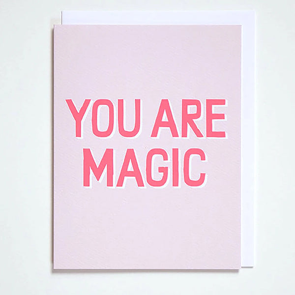 Greeting card on blush pink with the words "You are Magic" in neon pink by Banquet Workshop
