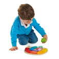 Child Playing with a Wooden Snake Puzzle with bright colors