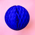 Paper honeycomb ball decoration in dark blue and 8 inches across