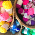 Baskets of colorful acrylic yarn