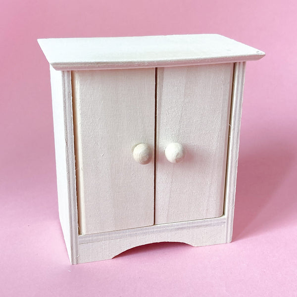 Miniature wooden dollhouse cabinet with doors