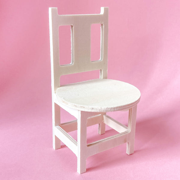 Miniature wooden dollhouse chair with round seat and closed back