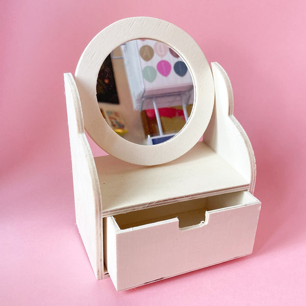 Miniature wooden dollhouse dresser with a round acrylic mirror