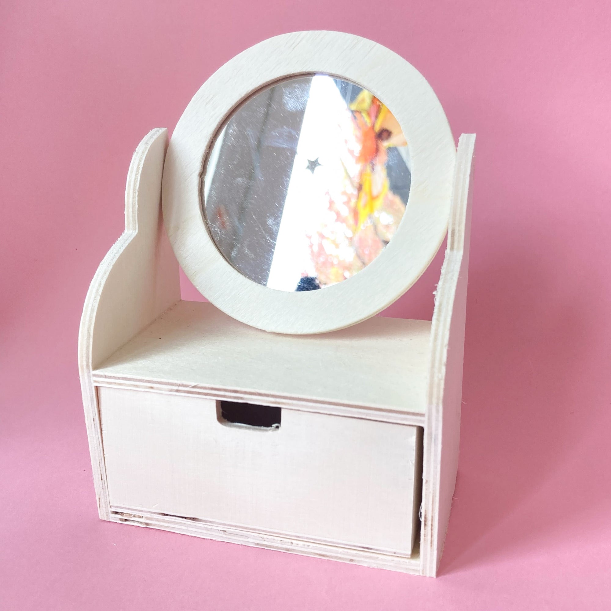 Miniature wooden dollhouse dresser with a round acrylic mirror