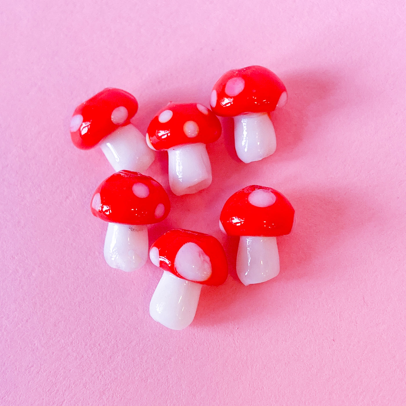 Glass mushroom beads in light red