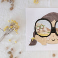 Neets Anita Cheung paper cut art print with a child looking though binoculars at a desert scene