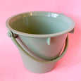 A bucket sand toy for children in light green eco plastic