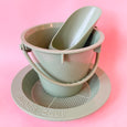 A bucket, scoop and Sieve Sand toys for children in light green eco plastic