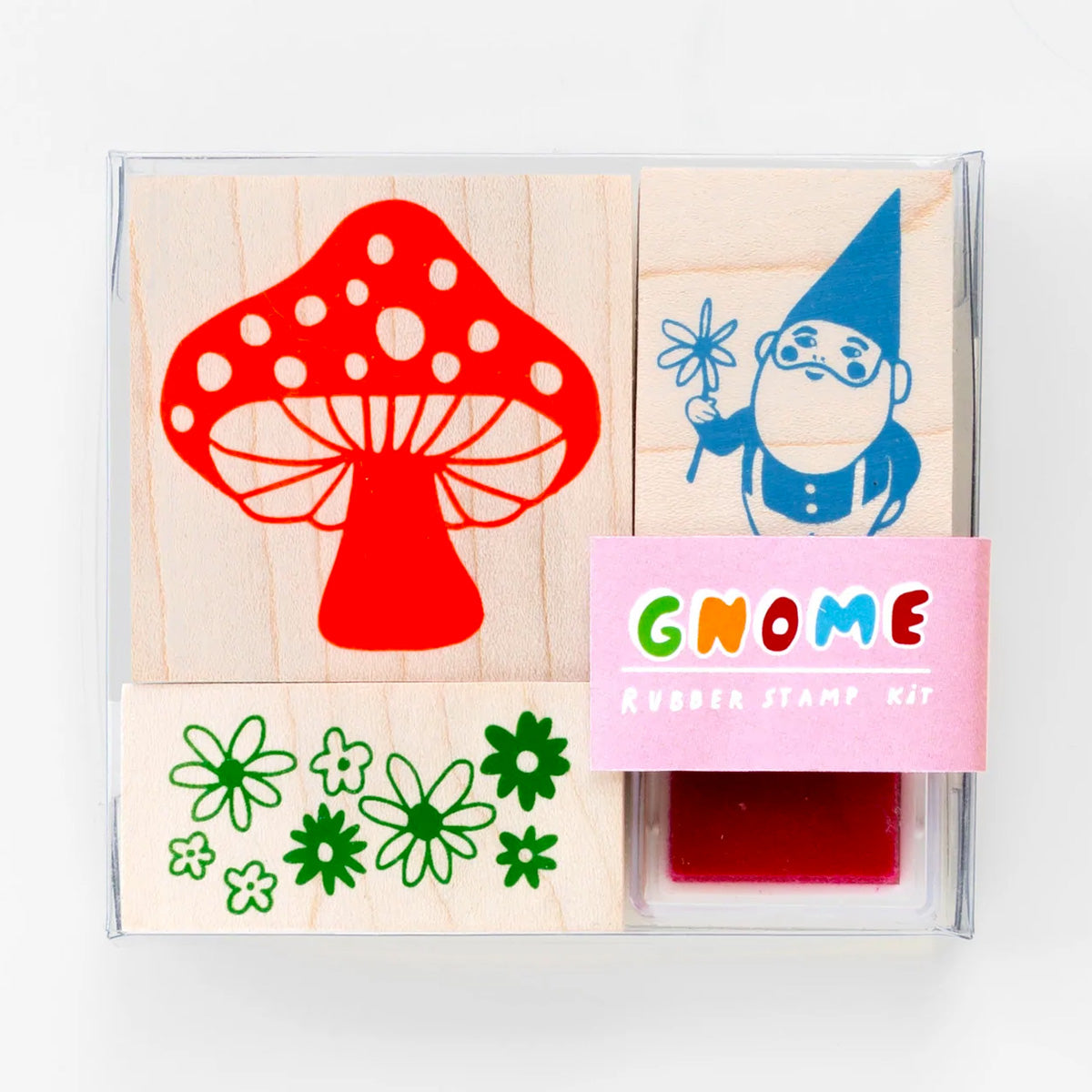 Three rubber stamps with a gnome, mushroom and some flowers.