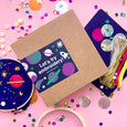 Space Embroidery Kit for Kids with 6" Bohdin Embroidery Hoop, several pieces of dark blue fabric, a needle, embroidery floss, big and small sequins, felt
