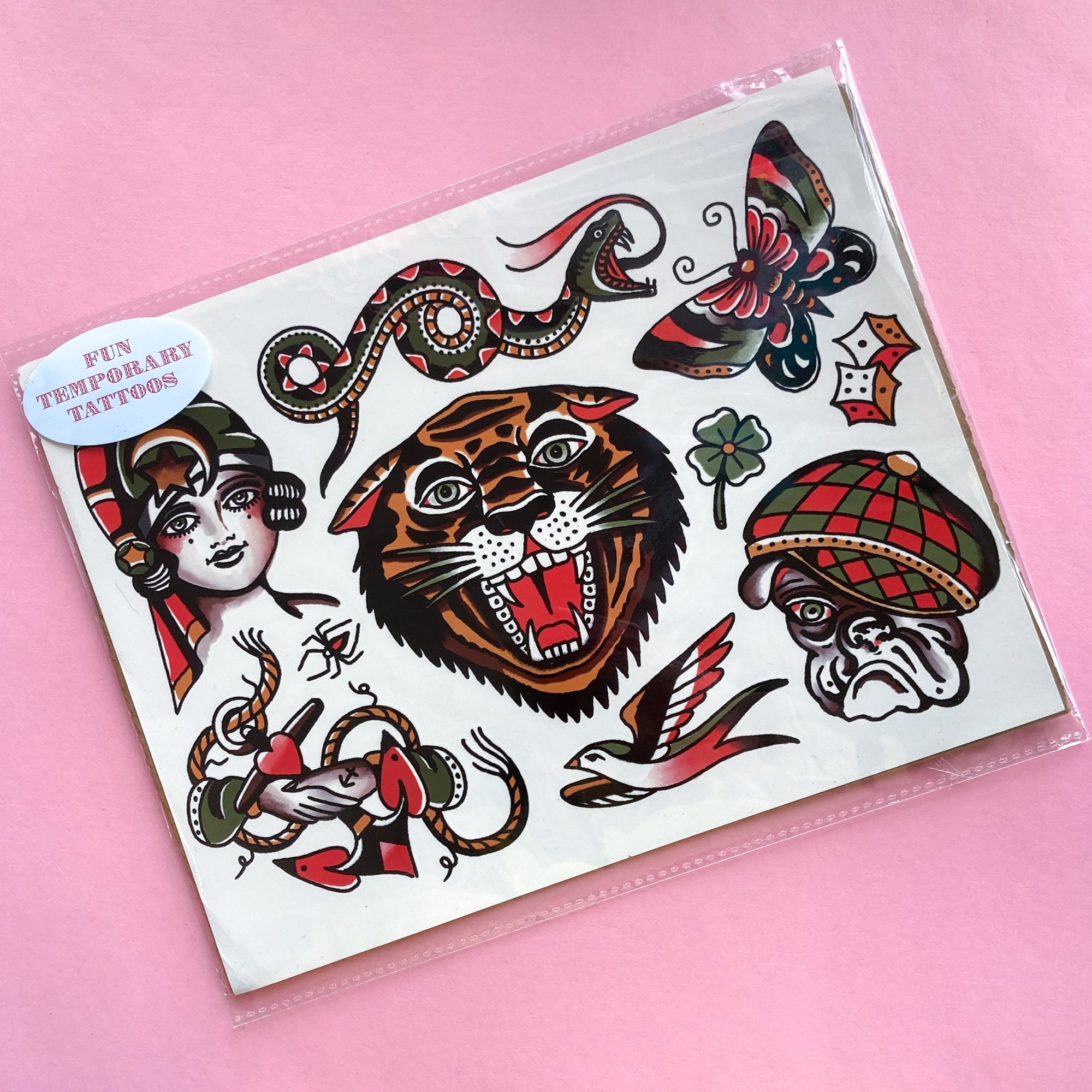 Temporary tattoo sheet with a tiger, snake, butterfly, dog, lady, bird and more