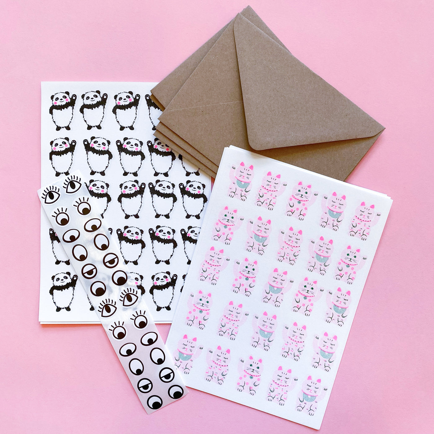 Writing paper with pandas and lucky cat designs. They come with eye stickers and brown kraft envelopes.